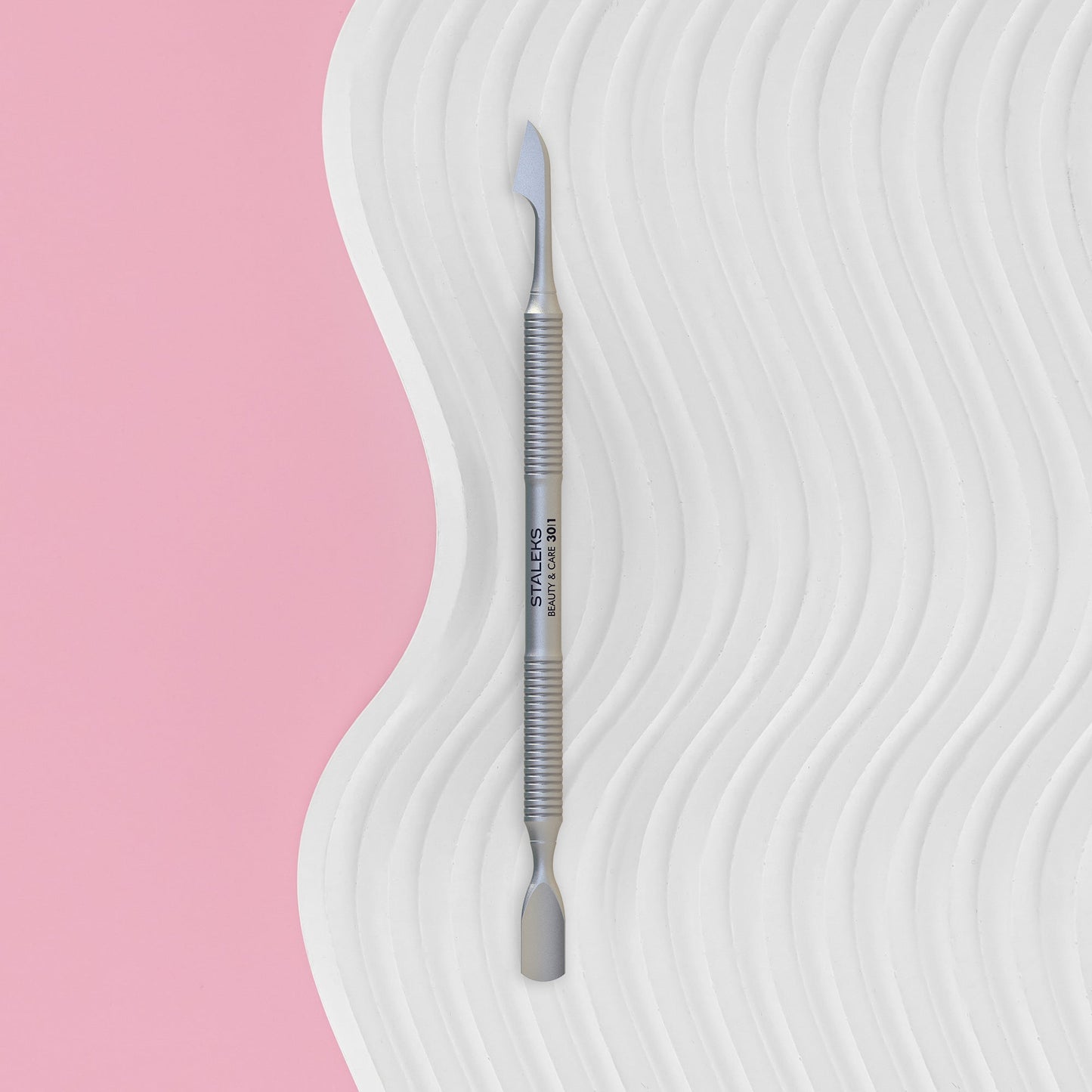 Manicure Pusher BEAUTY & CARE 30 TYPE 1 (Rounded Narrow Pusher And Cleaner)with 'Staleks' branding on a wavy white and pink background