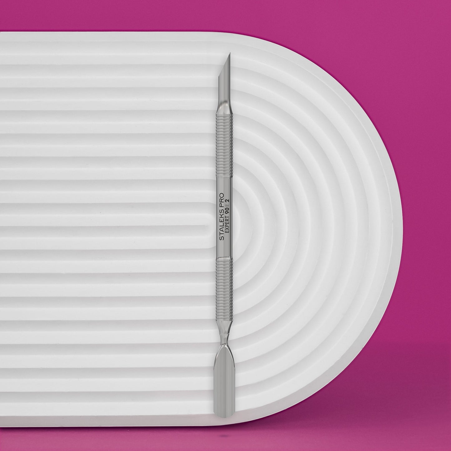 Manicure Pusher EXPERT 90 TYPE 2 (Beveled And Rounded Wide Pusher) on a white platform with a purple background