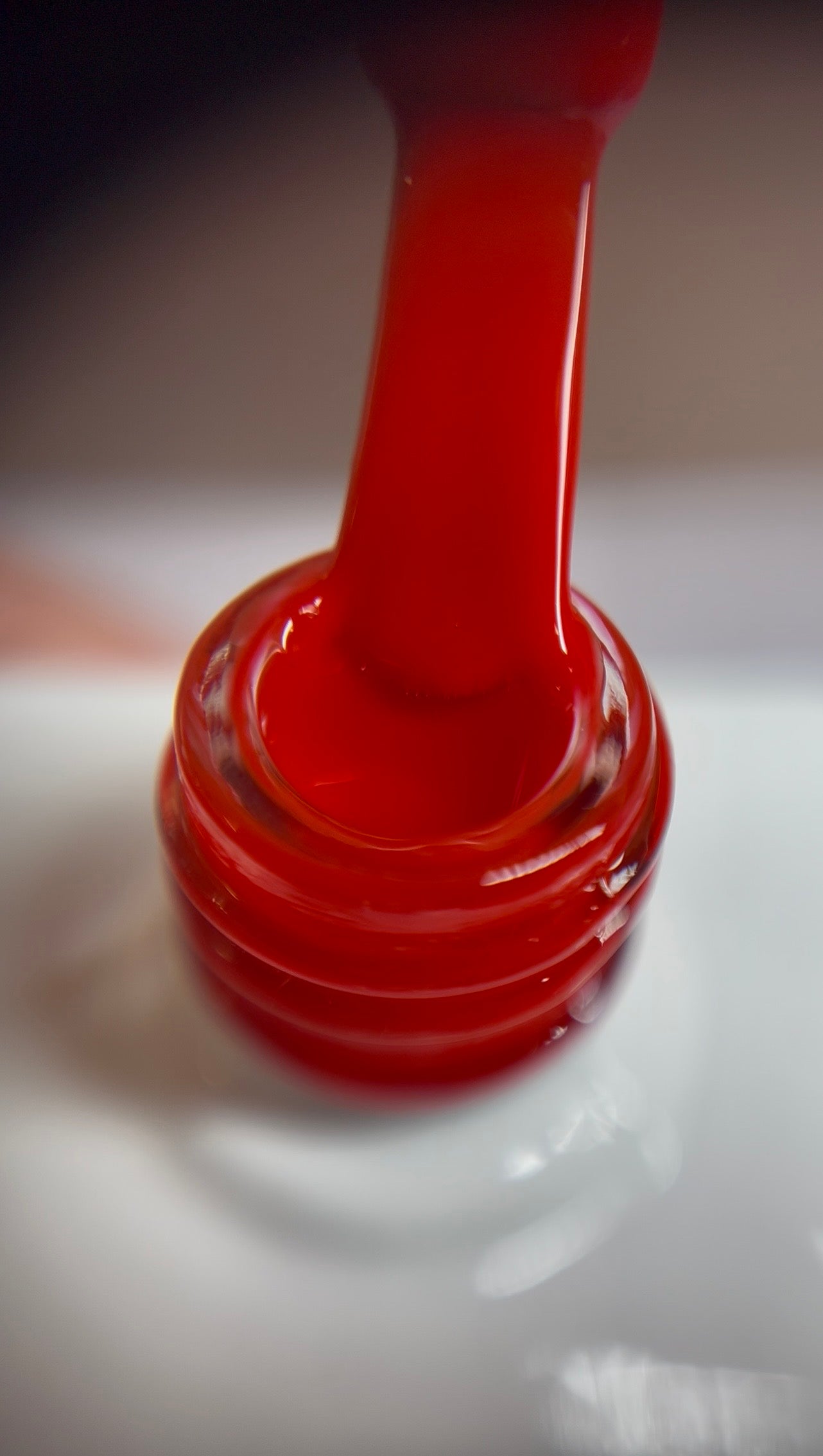 Warm red with a subtle orange undertone and glossy shine. TPO & HEMA free.