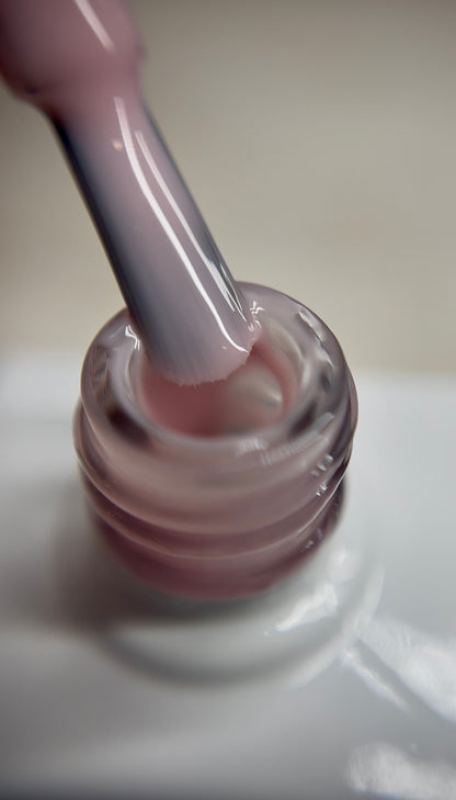 Translucent pink peach nude gel polish with a soft warm undertone and sheer finish. A natural-looking nude shade for professional salon use, perfect for fresh nail looks, French bases, and layered designs. Smooth application with thin layers. TPO-free and HEMA-free.
